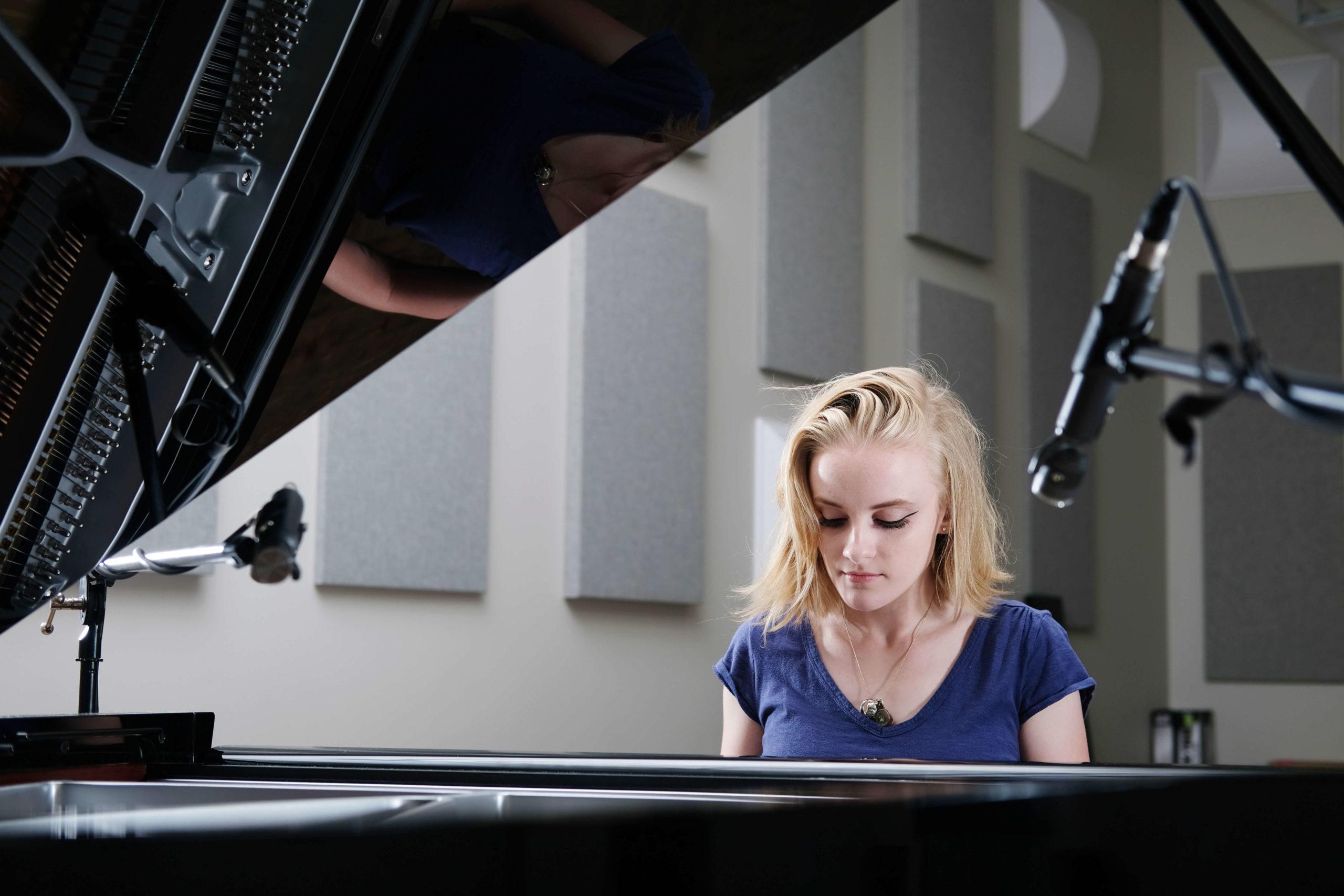 student at piano in recording studio