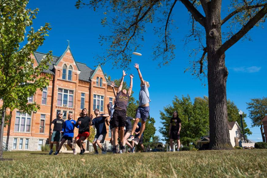 college students playing ultimate frisbee