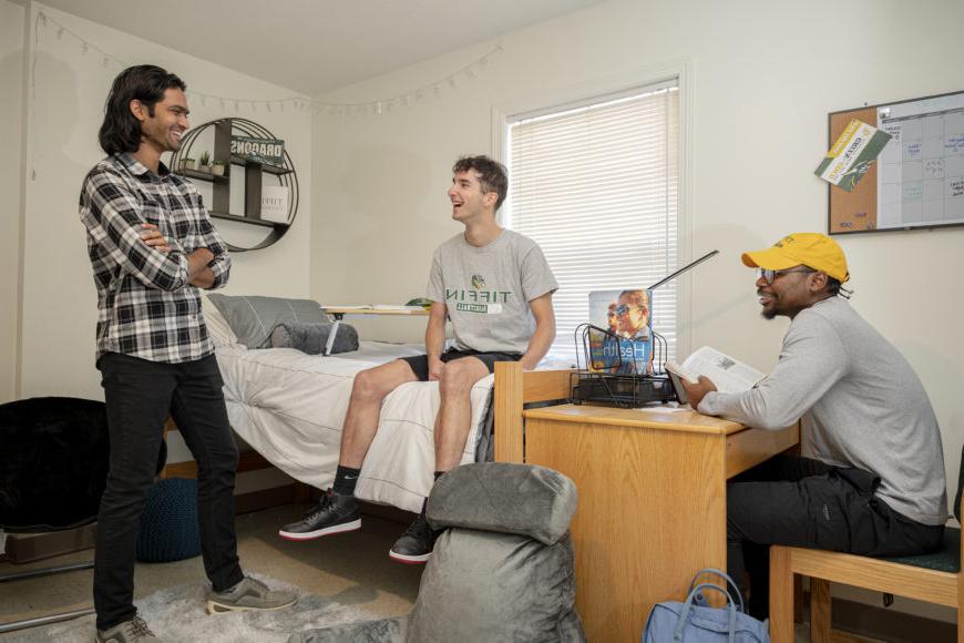 Group of students talking in dorm room